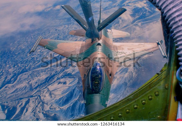 Aerial\
refueling mission over Alaska with an\
F-16
