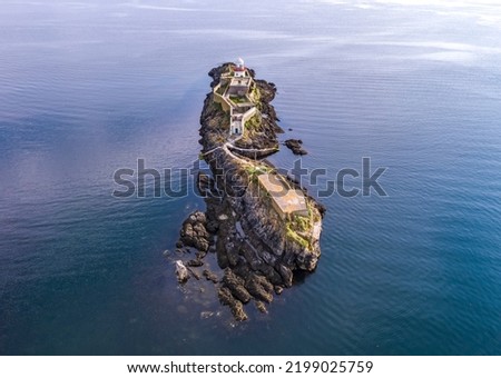 Aerial of the Rotten Island Lighthouse with Killybegs in background - County Donegal - Ireland