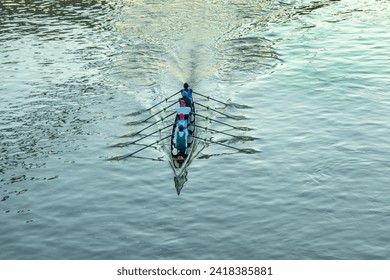 aerial of rower in early morning at the river in an five people boat - Powered by Shutterstock