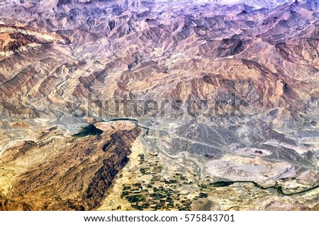 Aerial satellite birds eye view of desert mountains with river valley agriculture fields scenery at south east of islamic republic of Iran in middle east earth landscape nature landmark background