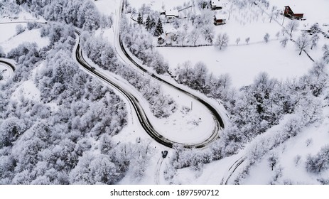 An Aerial Shot Of A Beautiful Winter Landscape With A Long Winding Road In The Countryside