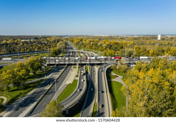 Aerial shot of a big freeway intersection in\
Warsaw, traffic going fast through many road flyovers. Warsaw,\
Poland. \
15. October.\
2019.