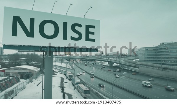 Aerial shot of a billboard with NOISE text at\
urban highway in winter