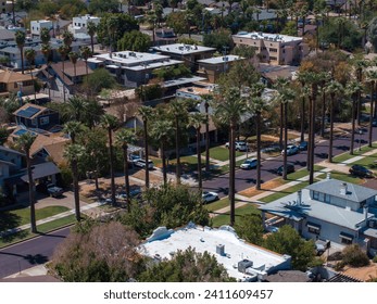 An aerial shot of Californian palms with an empty road. Palm trees and desert mountain in Palm Springs, California. - Powered by Shutterstock