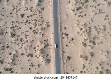 Aerial Shot Of Car Moving On The Barren Desert