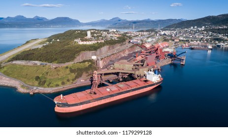 Aerial Shot Of A Cargo Ship Anchoring In  Port Terminal And Loading Iron Ore, Narvik, Norway