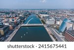 An aerial shot of cityscape of Dublin and the Samuel Beckett Bridge, a cable-stayed swingbridge in Ireland