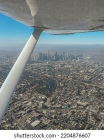 Aerial Shot Of Downtown Los Angeles Looking Out From A Small Plane, Plane Wing Visible