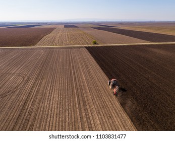 Aerial shot of a farmer plowing stubble field - Shutterstock ID 1103831477