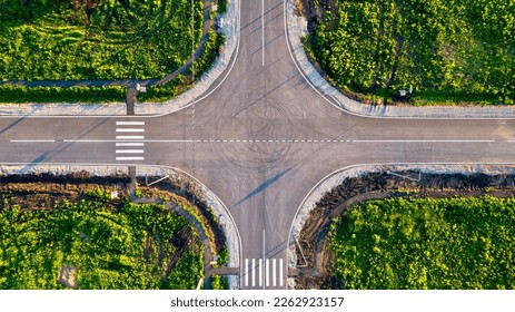  Aerial shot of a flat automobile intersection.  A flat road with markings. View from the height of the highway