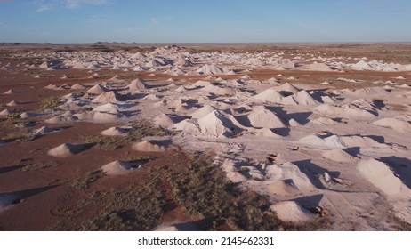 aerial shot flying over opal mine tailings at coober pedy on a winter afternoon