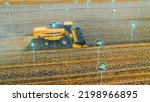 Aerial Shot: Harvester Working on Field. Visualization of the Crops Growing Efficiency with AI Data Analysis Icons. Futuristic Agriculture Concept of Computerized, Eco, Sustainable way of Harvesting