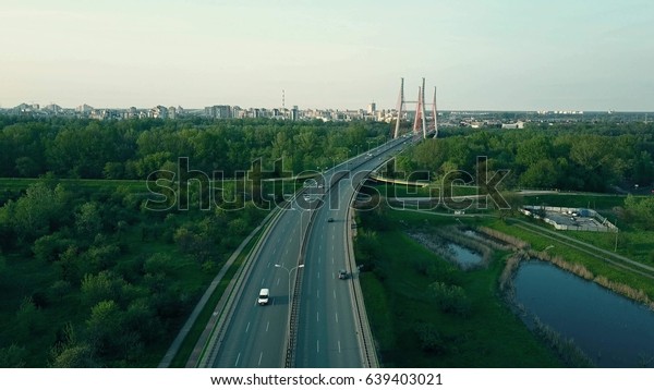Aerial\
shot of highway and guyed car bridge in\
Warsaw