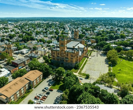 Aerial shot of the historic Cranston Street Armory in Providence, Rhode Island against a picturesque blue sky background