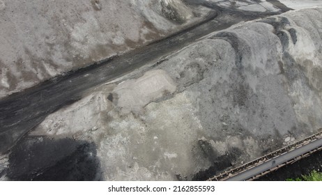 Aerial Shot Of A Large Ash Dump Created By Burning A Large Amount Of Coal. Located Near The City Center