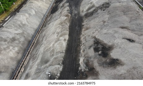 Aerial Shot Of A Large Ash Dump Created By Burning A Large Amount Of Coal. Located Near The City Center