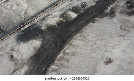 Aerial Shot Of A Large Ash Dump Created By Burning A Large Amount Of Coal. Located Near The City Center