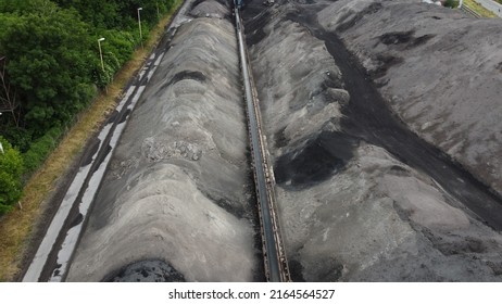 Aerial Shot Of A Large Ash Dump Created By Burning A Large Amount Of Coal. Located Near The City Center