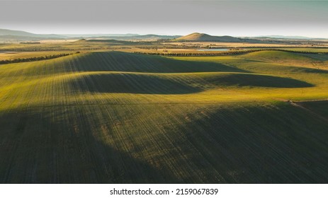 An Aerial Shot Of A Large, Green Landscape With Hills And Meadows