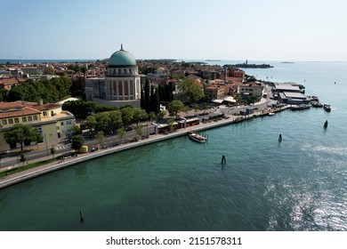 An aerial shot of the Lido island with sea and boats on a sunny day in Venice, Italy