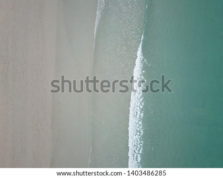 Similar – Luftaufnahme Panoramadrohne Blick auf den blauen Ozean Wellen, die am Sandstrand in Portugal erdrücken.