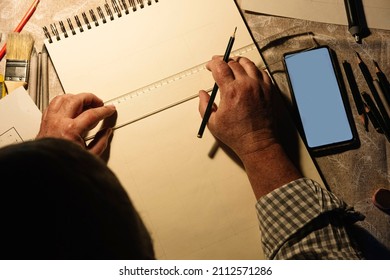 Aerial shot man's hand holding ruler   pencil while drawing  Seniors activities concept 
