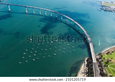 An aerial shot of the Mission bridge in San Diego, California, surrounded by the ocean