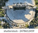 An aerial shot of the Odeon of Herodes Atticus stone Roman theatre structure in Athens, Greece.