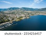 An aerial shot of the Okanagan Lake with Penticton city on the shore and hills in the background