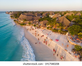 Aerial Shot On Zanzibar A Beautiful Sunset With People Walking On The Nungwi Beach In Zanzibar In Tanzania