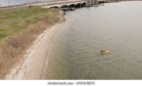 An Aerial Shot Over A Salt Marsh On A Sunny Day. In The Shot Is A Man In A Yellow Kayak In The Green Waters. Taken Near The Wantagh Parkway On Long Island, NY.