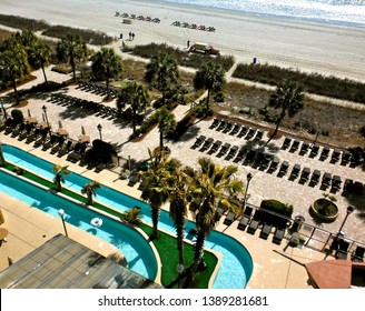 An Aerial Shot Of A Resort's Beach And Lazy River In Myrtle Beach, South Carolina 