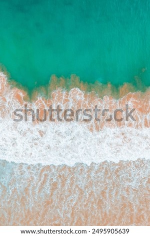 Similar – Luftaufnahme Panoramadrohne Blick auf den blauen Ozean Wellen, die am Sandstrand in Portugal erdrücken.