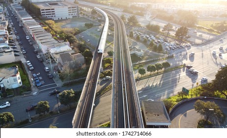 An Aerial Shot Of The San Francisco Bay Area Rapid Transit  (BART)the  Train Approaches Daly City Station, USA