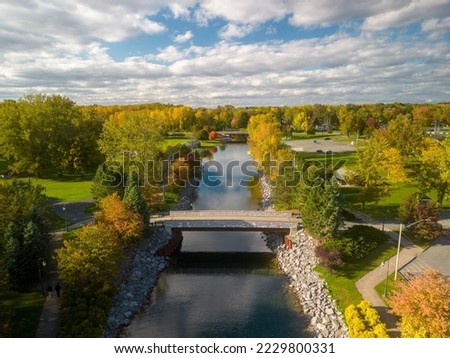 An aerial shot of the scenic Emerson Park in Auburn New York with flowing water and green vegetation