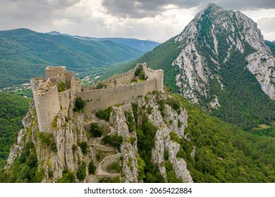 Aerial shot showing the Medieval Puilaurens castle and the Canigou mount in the Pyrénées mountain, France