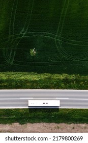 Aerial Shot Of Shuttle Bus Driving Along The Highway Through Cultivated Landscape, Drone Pov Directly Above