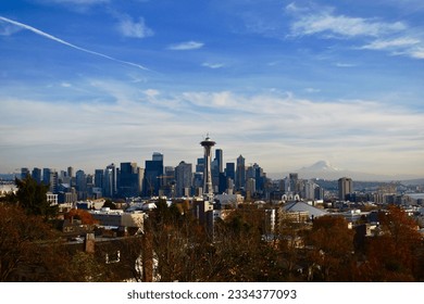 An aerial shot of the Space Needle in Seattle with Mount Rainier in the background - Powered by Shutterstock