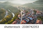 Aerial shot of sunny slightly foggy morning in Veliko Tarnovo, Bulgaria. Flying over old houses, Ascension Cathedral and river in the canyon in Veliko Tarnovo 2