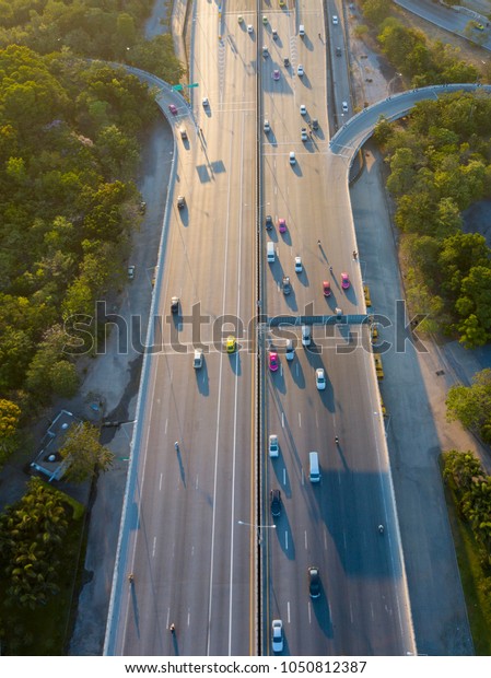 aerial shot of super highway traffic with cars and\
busy roads in day time