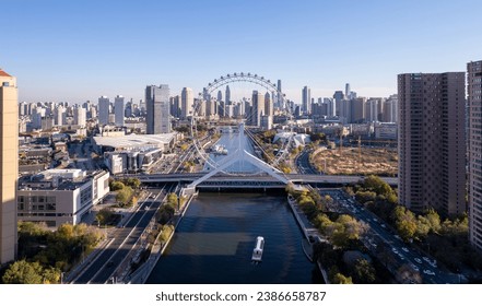 An aerial shot of the Tianjin Eye over the lake amid the skyscrapers, China