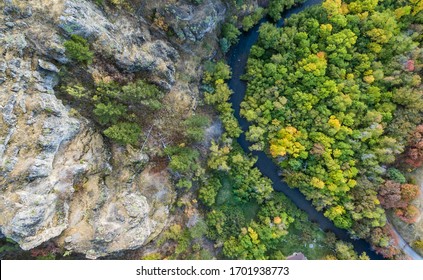 Aerial shot of trees changing to autumn colors with a flowing river in Logan Canyon of northern Utah