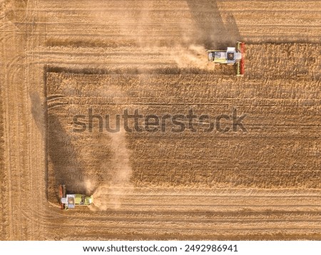 Similar – Combine harvester harvests a grain field in the evening light from the air