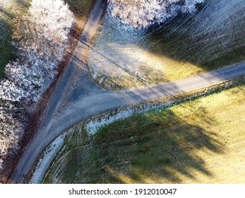 An Aerial Shot Of Two Roads Meeting Each Other By The Snow-covered Fields