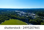 an aerial shot of the vast miles of lush green trees and grass with buildings nestled among the trees and powerful clouds at sunset at Etowah River Park in Canton Georgia USA	