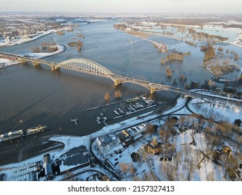 An Aerial Shot Of A Waal Bridge With Snow Covered City