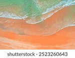 Aerial shot of waves and sand patterns on a beach in Sydney Australia