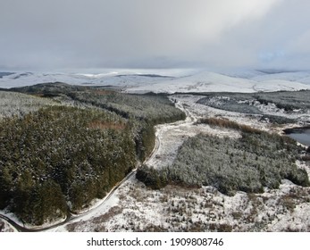 Aerial Shots Of Dramatic Rural Mountainous Scenery Under Heavy Overcast Clouds And Light Blanket Of Snow