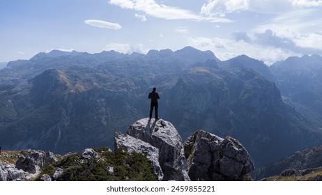 Aerial shots of Prokletije Mountain, revealing its rugged beauty. Hikers traverse its slopes, immersed in nature's grandeur. - Powered by Shutterstock