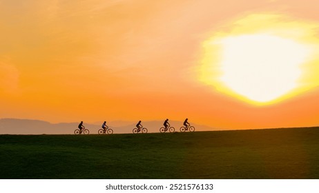 AERIAL, SILHOUETTE, LENS FLARE: Five mountain bikers riding in a line along a hilltop, bathing in breathtaking sunset light. Beauty of shared outdoor adventures and the tranquillity of the evening. - Powered by Shutterstock